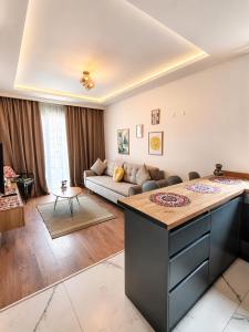 a living room with a couch and a table at Dreams house elia in Budva +1 photo