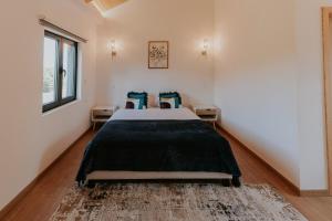 a bedroom with a large bed in a room at Quinta do Codeçal in Vila Real