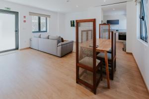 a living room with a table and a couch at Quinta do Codeçal in Vila Real