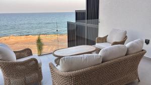 a living room with chairs and a view of the ocean at Fins Dream Villas in Fins