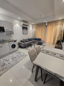 a living room with a couch and a table at Hawana VIP Appartment in Ma‘mūrah
