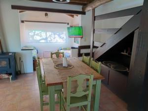 a dining room with a wooden table and chairs at Casita Naranja in La Calera