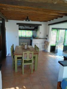 a kitchen and dining room with a table and chairs at Casita Naranja in La Calera +23 photos