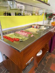a buffet line with meat and other food items at Hotel Mosel Star in Bernkastel-Kues