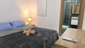 a bedroom with a bed with a pair of towels on it at One in Se7en in St. Julianʼs