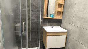 a bathroom with a sink and a shower at One in Se7en in St. Julianʼs +24 photos
