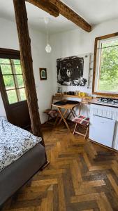 a room with a kitchen with a table and a stove at Retreat în padure in Buchin