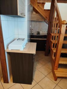 a kitchen with a sink and a staircase in a room at Domek u Ewy w Spychowie in Spychowo