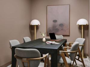 a dining room with a black table with chairs and a laptop at Kasa Lake Shore Chicago in Chicago