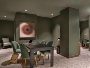 a dining room with a table and green chairs at Kasa Lake Shore Chicago in Chicago