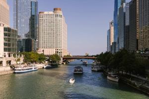 a river with boats in a city with tall buildings at Kasa Lake Shore Chicago in Chicago +20 photos