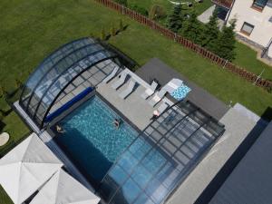 an overhead view of a swimming pool with a glass house at Ośrodek Wypoczynkowy Baca in Poronin