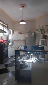 a large kitchen with a table in the middle at Apartamento in Montes Claros