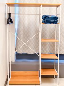 a closet with wooden shelves and blue clothes at ความเจริญที่เงียบสงบ in Bangkok