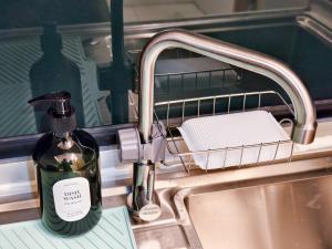 a bottle of soap is sitting in a sink at ความเจริญที่เงียบสงบ in Bangkok +44 photos