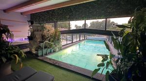 a swimming pool in a house with plants at Desirad in La Clisse