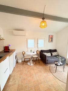 a living room with a couch and a table at La lavande in Arles