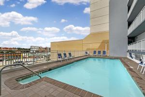 a swimming pool on the balcony of a building at SureStay Studio by Best Western Virginia Beach Oceanfront in Virginia Beach