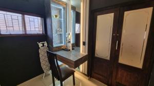 a room with a table and a chair and a window at Luxury Fairland Fully Serviced Cottages in Johannesburg