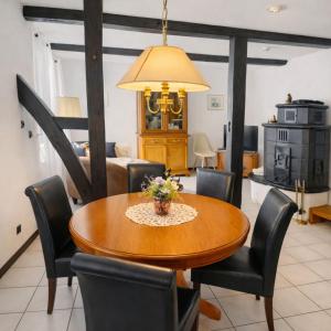 a dining room with a wooden table and chairs at Fachwerkhaus Bodenwerder in Bodenwerder