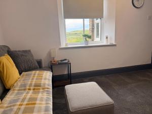 a living room with a bed and a window at Self contained property in Cartworth