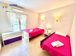 two beds in a small room with red sheets at Villa Marina - Inalko in Alcossebre +43 photos