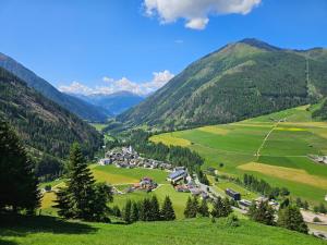 a small village in a valley in the mountains at Ferienwohnung Bergherz in Sankt Johann im Walde