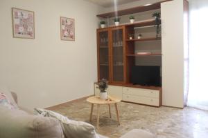 a living room with a couch and a table at Appartamento in Villa Nadin in Monte Compatri