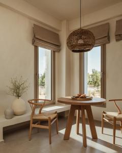 a dining room with a table and two chairs at Levante Afitos Suites - Adults Only in Afitos +47 photos