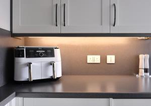 a microwave oven sitting on top of a kitchen counter at Number 9 in Fort William