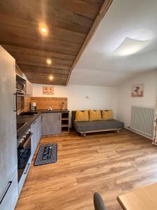 a kitchen with a couch in the middle of a room at Alpenecho in Neustift im Stubaital