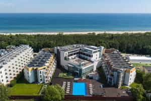an aerial view of a building next to the beach at Maloves Resort & Spa in Władysławowo