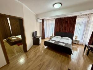 a bedroom with a bed and a television in it at Pensiunea Amnesia in Sovata