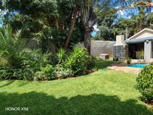 a yard with a pool and a house at F'leur Guesthouse in Mokopane