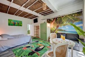 a bedroom with a bed and a table with chairs at lemasrocamour in Roquemaure