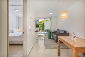 a living room with a couch and a table at Hotel Santa Ana Medellin in Medellín +72 photos