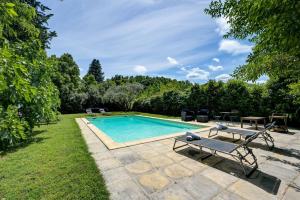 a swimming pool in a yard with a table and a bench at lemasrocamour in Roquemaure