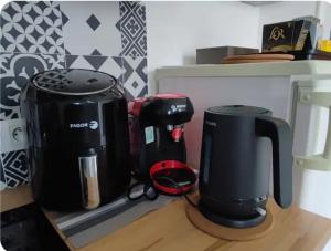 two coffee makers sitting on a counter in a kitchen at City 18 in Bourges
