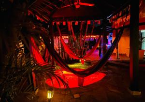 a hammock in a room at night with lights at HappiCasaRD & Holistic House in Sosúa