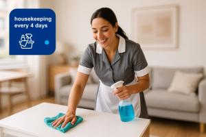 a woman cleaning a table with a bottle of cleaner at Trendy Apartment in Puerto Madero in Buenos Aires