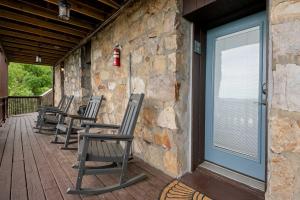 a row of rocking chairs sitting on a porch at Historic Riverview Inn Suite Nine in Chattanooga