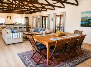 a living room with a wooden table and chairs at Adrenalin Addo Manor House in Addo