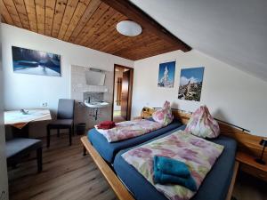 a bedroom with a bed and a desk and a table at Boabauer in Tamsweg