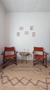 two chairs and a table in a room at Nomads nest safari house in Arusha