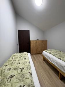 a bedroom with two beds in a room at DreamHouse in Cholpon-Ata