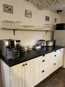 a kitchen with a black counter top at Bonaluti Adults - Azyl Dla Dorosłych in Mirsk +30 photos