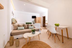 a living room with a couch and a table at Evnia apartments in Vóthon