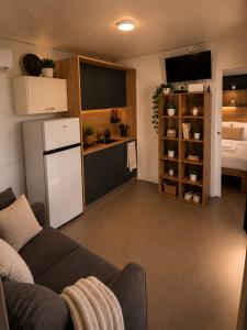 a living room with a couch and a kitchen at Mobilehome Lana in Privlaka