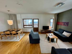 a living room with a couch and a table at Ylläs Chalets 7305 in Ylläs