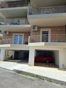 a red car parked in a parking lot in front of a building at Romantic Sparta Hideaway in Sparta
